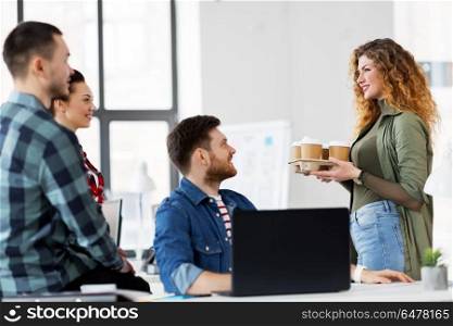 business and people concept - happy creative team with coffee working at office. happy creative team with coffee working at office. happy creative team with coffee working at office