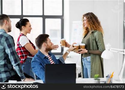 business and people concept - happy creative team with coffee working at office. happy creative team with coffee working at office. happy creative team with coffee working at office