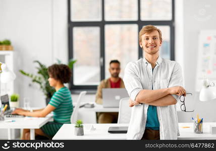 business and people concept - happy smiling man with glasses at office. happy smiling man with glasses at office. happy smiling man with glasses at office