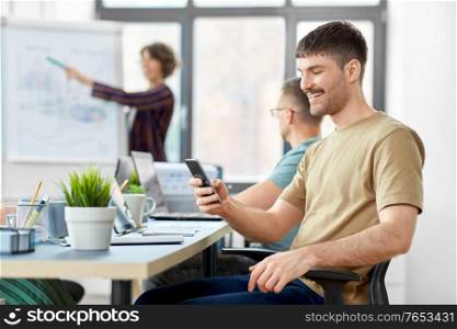 business and people concept - happy smiling man with smartphone at office conference. happy man with smartphone at office conference