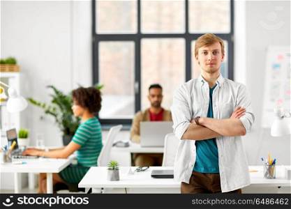 business and people concept - man with crossed hands at office. man with crossed hands at office. man with crossed hands at office