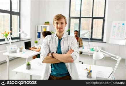 business and people concept - man with crossed hands at office. man with crossed hands at office