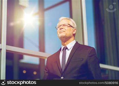 business and people concept - senior businessman on city street. senior businessman on city street
