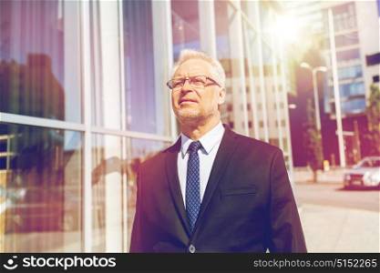 business and people concept - senior businessman on city street. senior businessman on city street