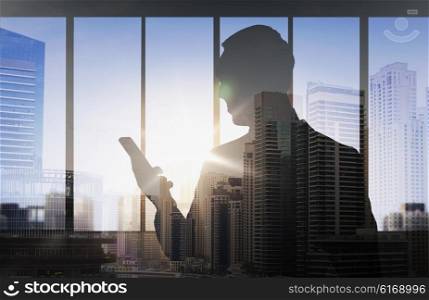 business and people concept - silhouette of businessman with smartphone over double exposure office and city background. silhouette of businessman with smartphone