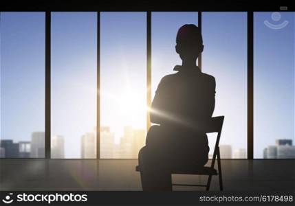 business and people concept - silhouette of woman sitting on chair over office window background. silhouette of business woman sitting on chair