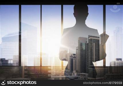 business and people concept - silhouette of woman with folders over double exposure office and city background. silhouette of businesswoman with folder over city