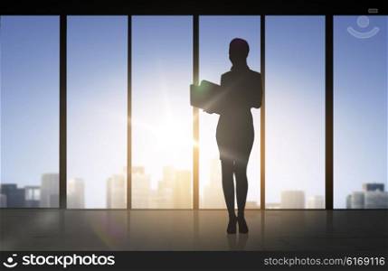 business and people concept - silhouette of woman with folders over office window background. silhouette of business woman with folders