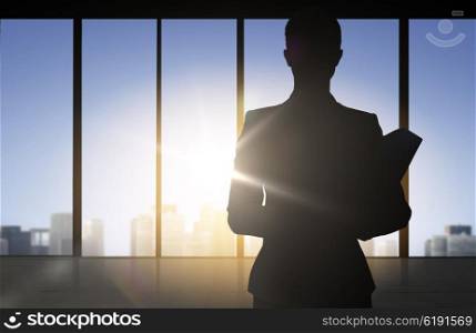 business and people concept - silhouette of woman with folders over office window background. silhouette of business woman with folders