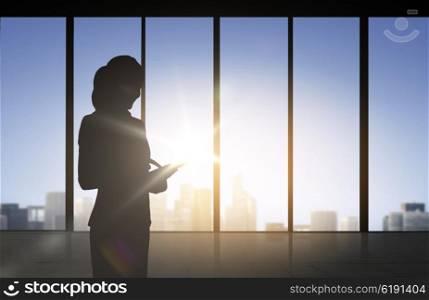 business and people concept - silhouette of woman with tablet pc over office window background. silhouette of business woman with tablet pc