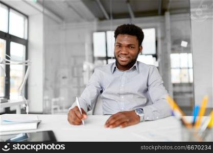 business and people concept - smiling african american businessman at office. smiling african american businessman at office. smiling african american businessman at office