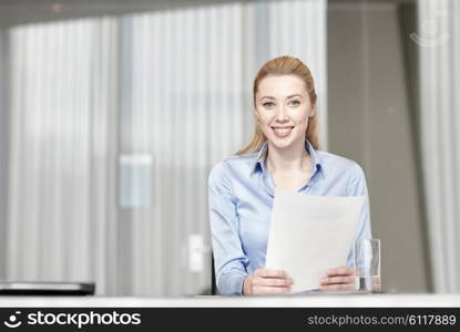 business and people concept - smiling woman holding papers in office. smiling woman holding papers in office