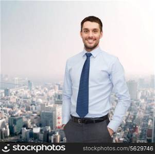 business and people concept - smiling young and handsome businessman over cityscape background