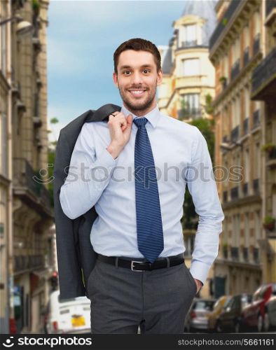 business and people concept - smiling young and handsome businessman over old city background