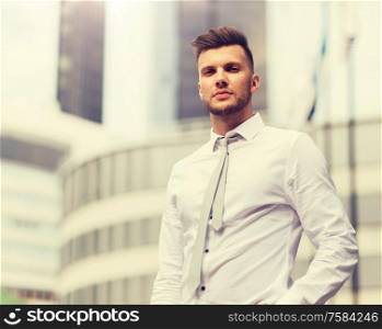 business and people concept - young man in shirt and tie on city street. young man in shirt and tie on city street