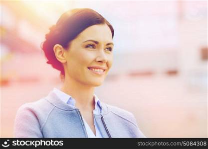 business and people concept - young smiling businesswoman over office building. young smiling businesswoman over office building. young smiling businesswoman over office building