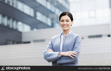 business and people concept - young smiling businesswoman over office building. young smiling businesswoman over office building