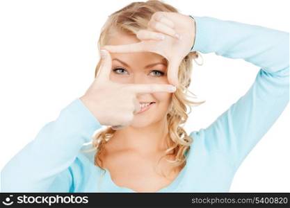 business and photography concept - woman creating a frame with fingers or snapshot