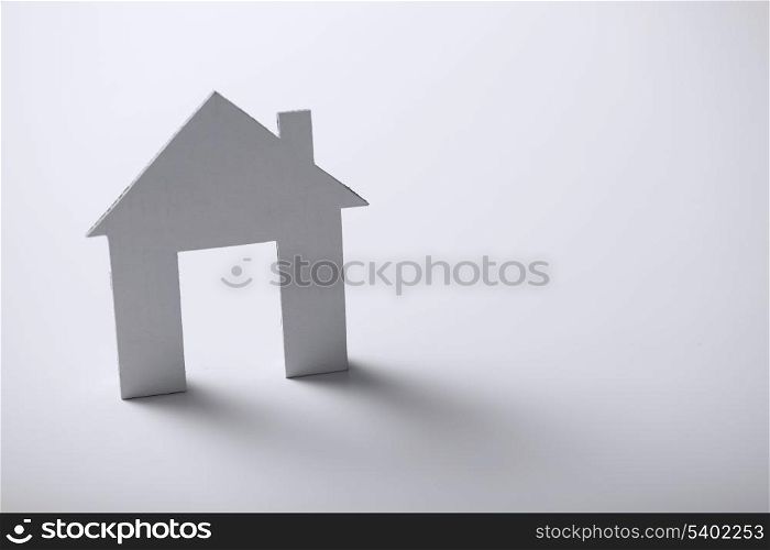business and real estate concept - white paper house over white background