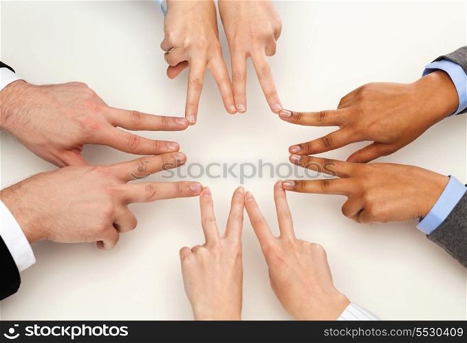 business and succcess concept - group of businesspeople showing v-sign