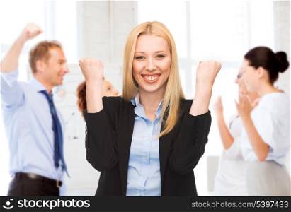 business and success - happy businesswoman celebrating succes in office