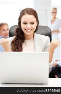 business and success - happy businesswoman with computer in office