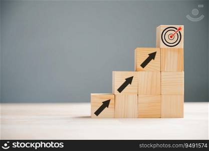 Business and target concept depicted by a hand positioning a print screen dart and wooden cube on upward arrows. Symbolizing success, development, and financial growth. White background.
