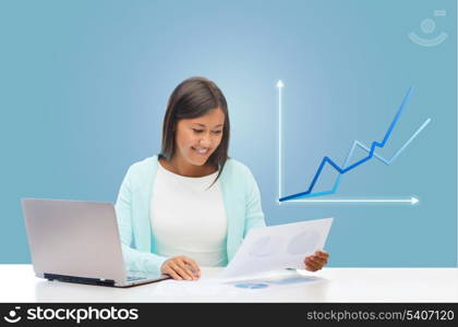 business and technology concept - asian businesswoman or student with laptop, documents and graph in office