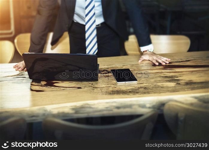 Business and technology concept. Businessman put hands on table . Business and technology concept. Businessman put hands on table with mobile and tablet computer. Picture for add text message. Backdrop for design art work.