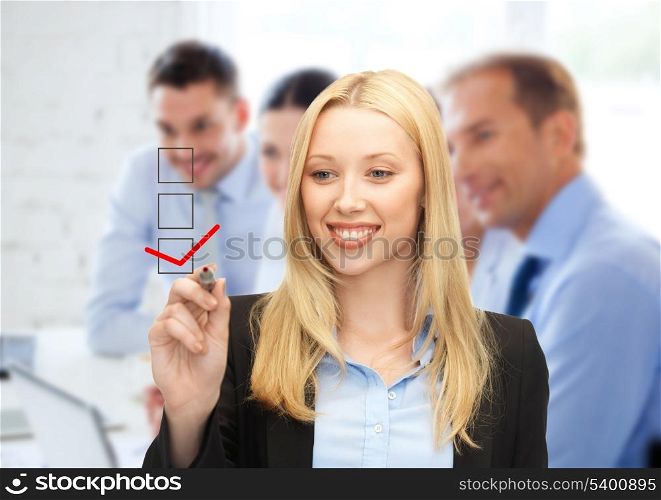 business and technology concept - businesswoman drawing checkmark on virtual screen