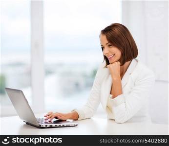 business and technology concept - businesswoman with laptop in office