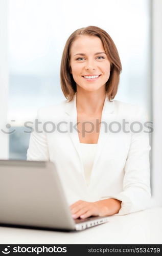 business and technology concept - businesswoman with laptop in office