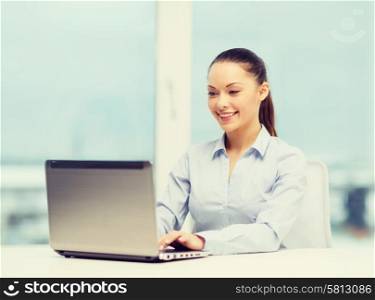 business and technology concept - businesswoman with laptop in office