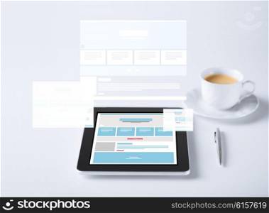 business and technology concept - close up of tablet pc computer with web page design template and cup of coffee. close up of tablet pc with web design template