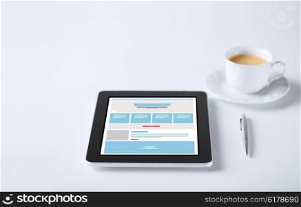 business and technology concept - close up of tablet pc computer with web page design template and cup of coffee. close up of tablet pc with web design template