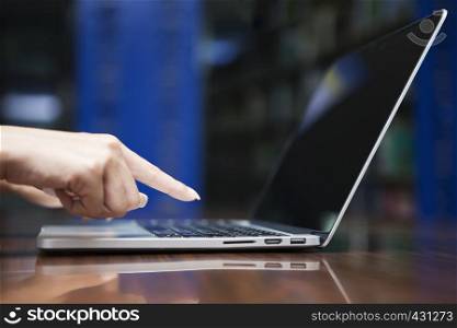 Business and technology concept. Closeup of hand working with laptop on table.