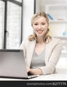 business and technology concept - happy woman with laptop computer