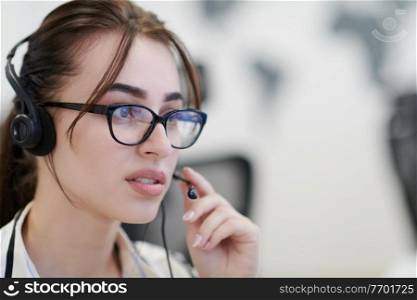 business and technology concept - helpline female operator with headphones in call centre Business woman with headsets working in a call center