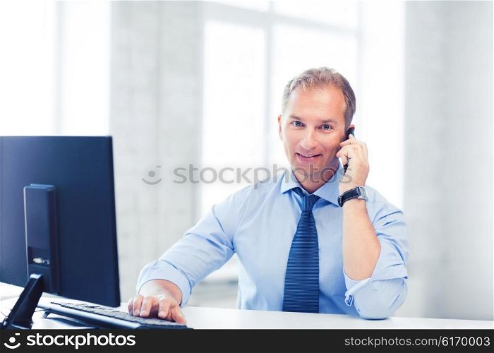 business and technology concept - smiling businessman with smartphone in office. smiling businessman with smartphone in office