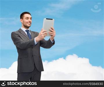 business and technology concept - smiling businessman with tablet pc computer