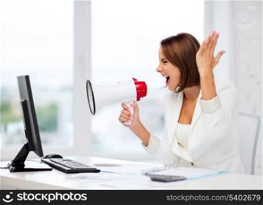 business and technology concept - strict businesswoman shouting in megaphone in office