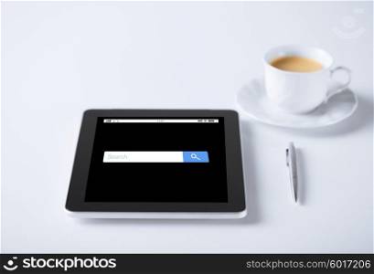 business and technology concept - tablet pc computer with internet browser search bar and cup of coffee. tablet pc with internet browser search and coffee