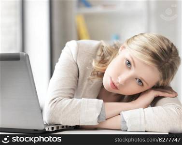 business and technology concept - tired woman with laptop computer