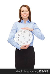 business and time concept - attractive businesswoman with wall clock