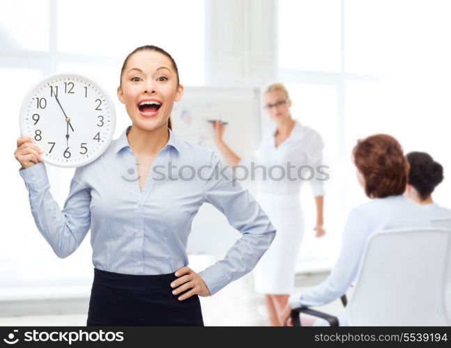 business and time concept - attractive businesswoman with wall clock