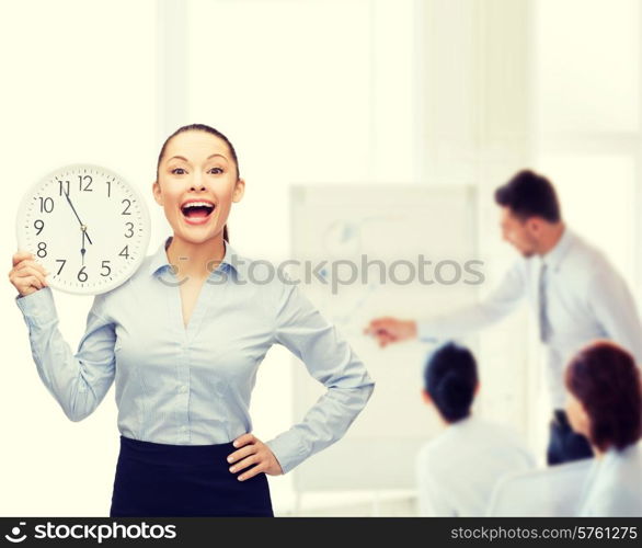 business and time concept - attractive businesswoman with wall clock