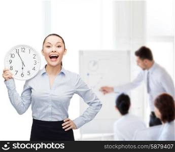 business and time concept - attractive businesswoman with wall clock. attractive businesswoman with wall clock