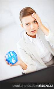 business and time management concept - stressed businesswoman holding clock