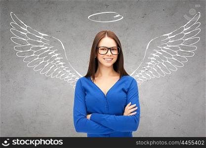 business, angel investor, safety, security and people concept - smiling young businesswoman with wings and nimbus drawing over gray concrete background