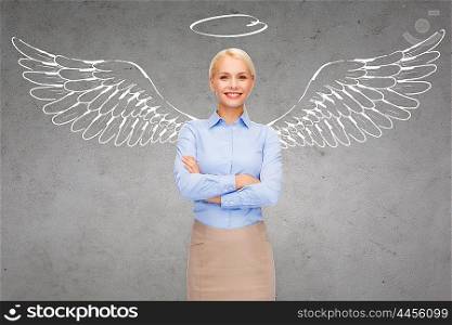 business, angel investor, safety, security and people concept - smiling young businesswoman with wings and nimbus drawing over gray concrete background